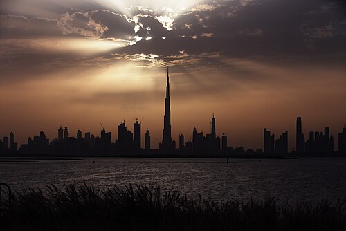 Burj Khalifa towering over the Dubai skyline at sunset